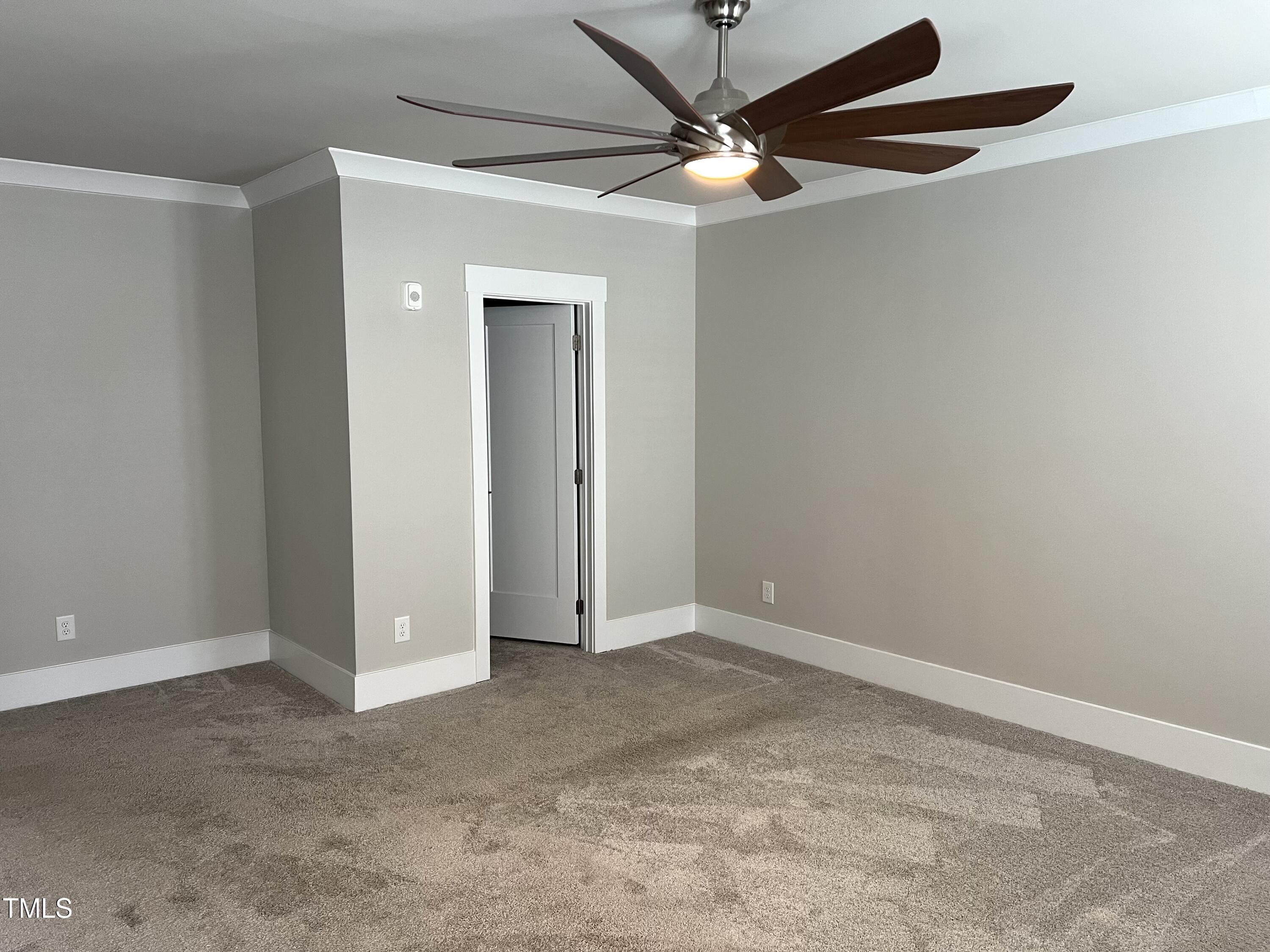 10530 Sablewood Drive, Unit 113 Raleigh, NC 27617 - Photo 28 of 61 an empty room with a fan and a ceiling fan
