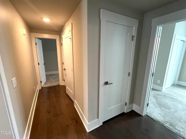 an empty room with closet and a ceiling fan