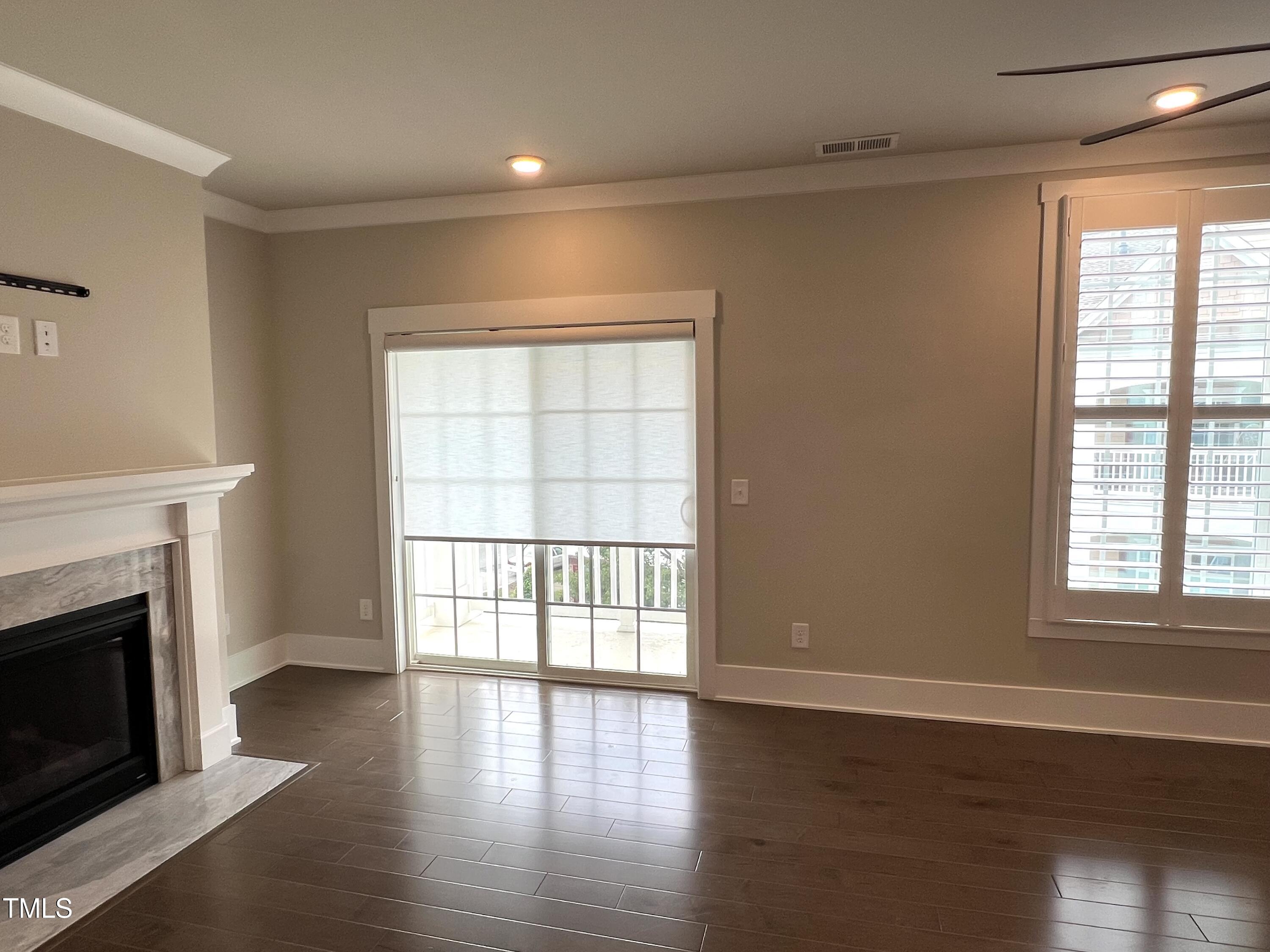 10530 Sablewood Drive, Unit 113 Raleigh, NC 27617 - Photo 34 of 61 a view of an empty room with wooden floor and a window