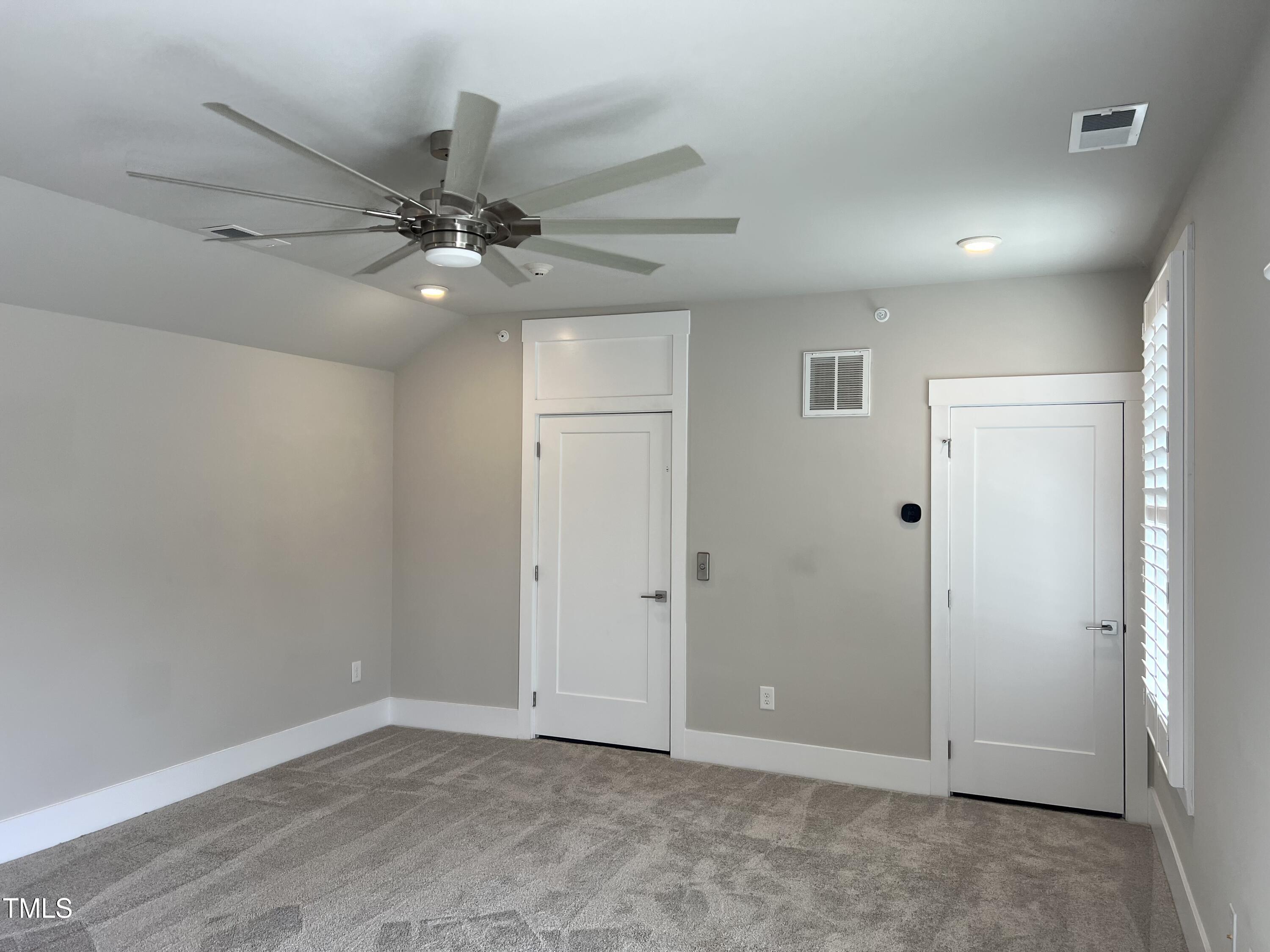 10530 Sablewood Drive, Unit 113 Raleigh, NC 27617 - Photo 42 of 61 an empty room with fan and a ceiling fan