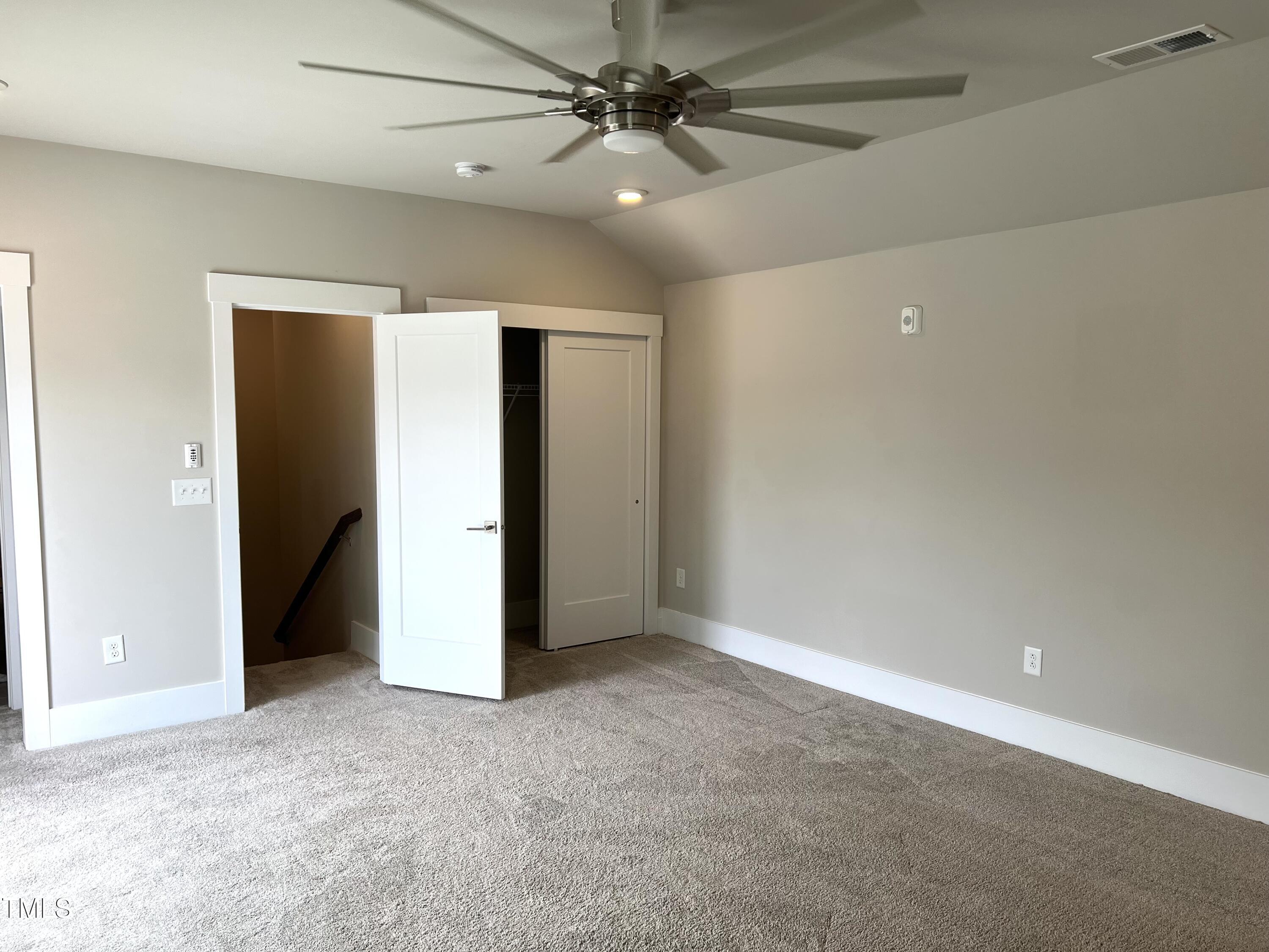 10530 Sablewood Drive, Unit 113 Raleigh, NC 27617 - Photo 43 of 61 an empty room with closet and a ceiling fan