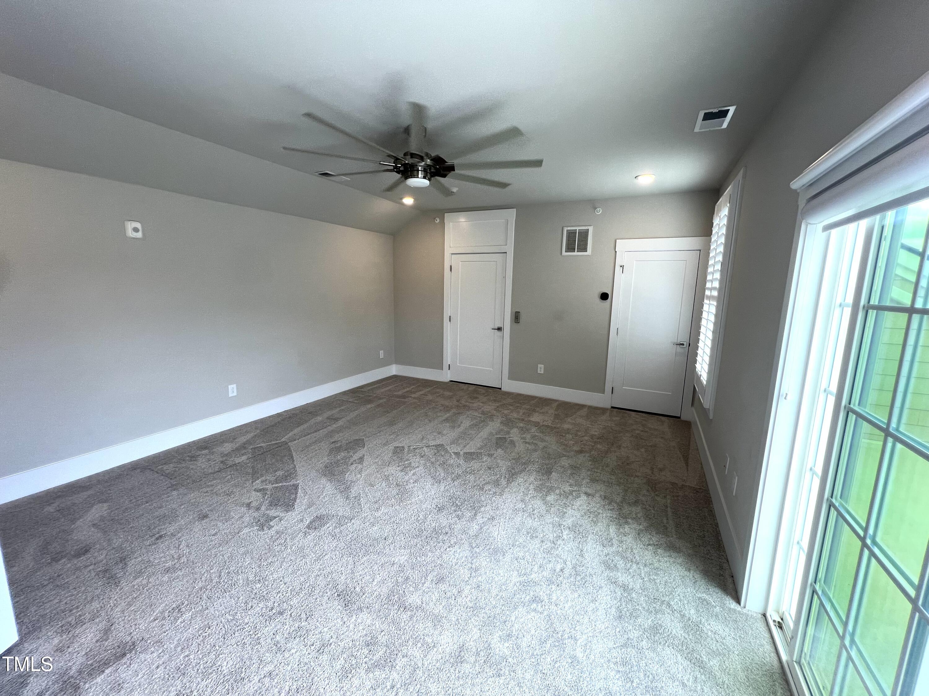 10530 Sablewood Drive, Unit 113 Raleigh, NC 27617 - Photo 45 of 61 en empty room with windows and ceiling fan