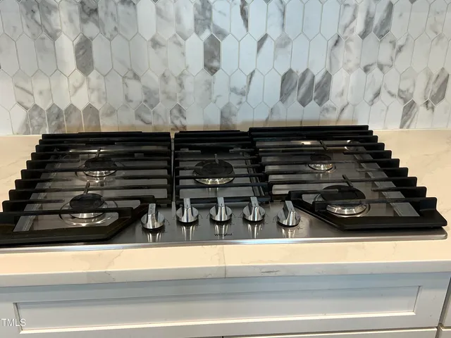 a kitchen with a sink a counter top space stainless steel appliances and a window