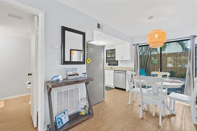 a kitchen with a sink cabinets and wooden floor