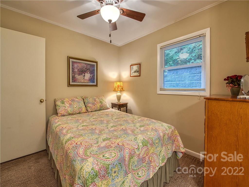 2660 Hemphill Road Waynesville, NC 28785 - Photo 25 of 43 a bedroom with a bed and a painting on the wall