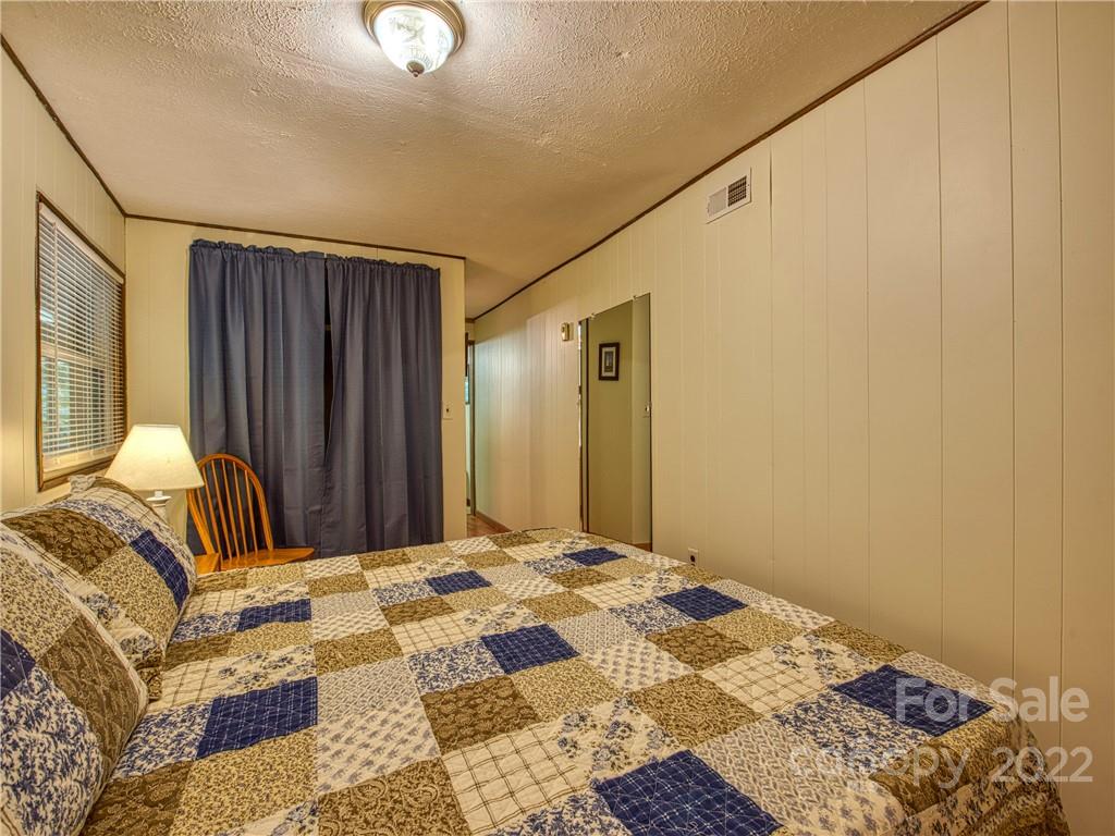 2660 Hemphill Road Waynesville, NC 28785 - Photo 35 of 43 a bedroom with a bed and a dresser