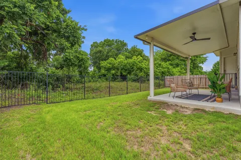 a view of a backyard with a garden and deck