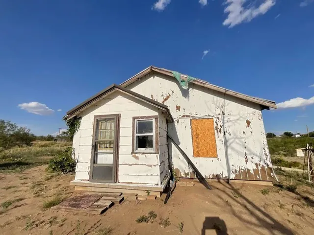 a view of a house with wooden fence