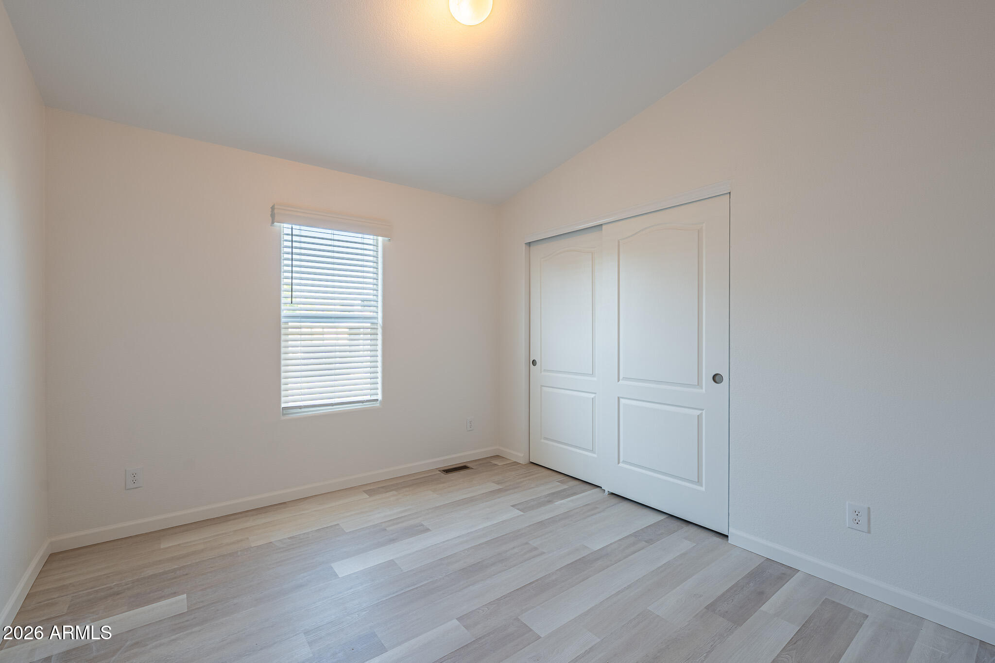 1250 East Bell Road, Unit 11 Phoenix, AZ 85022 - Photo 18 of 24 an empty room with wooden floor and window