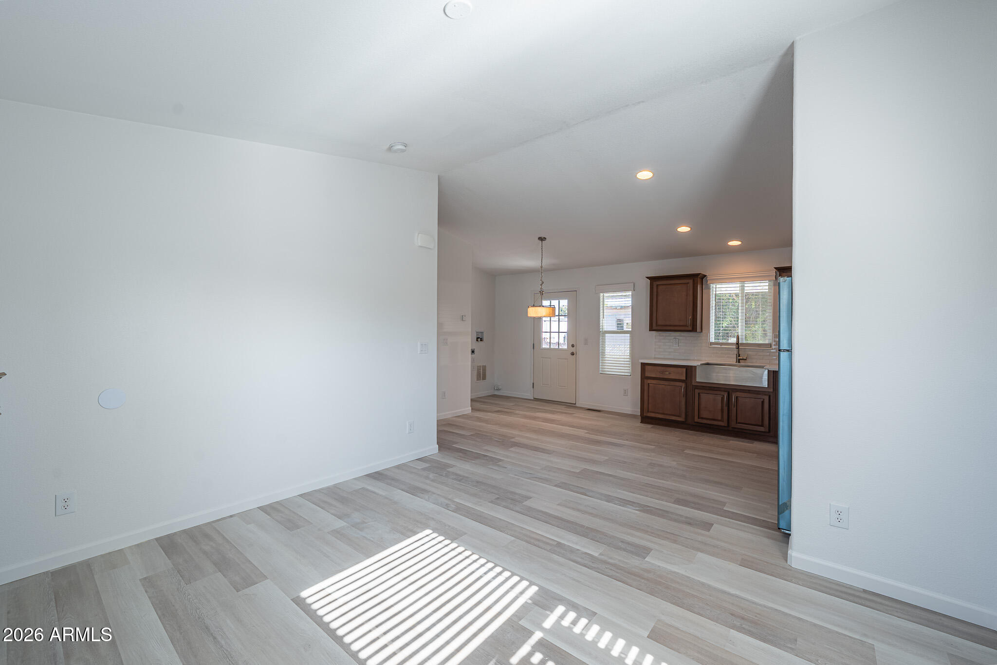 1250 East Bell Road, Unit 11 Phoenix, AZ 85022 - Photo 5 of 24 a view of a kitchen with a sink and a refrigerator