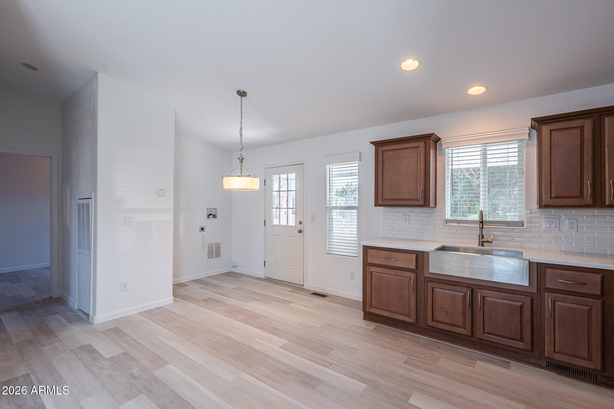1250 East Bell Road, Unit 11 Phoenix, AZ 85022 - Photo 6 of 24 a view of a kitchen center island wooden floor and windows