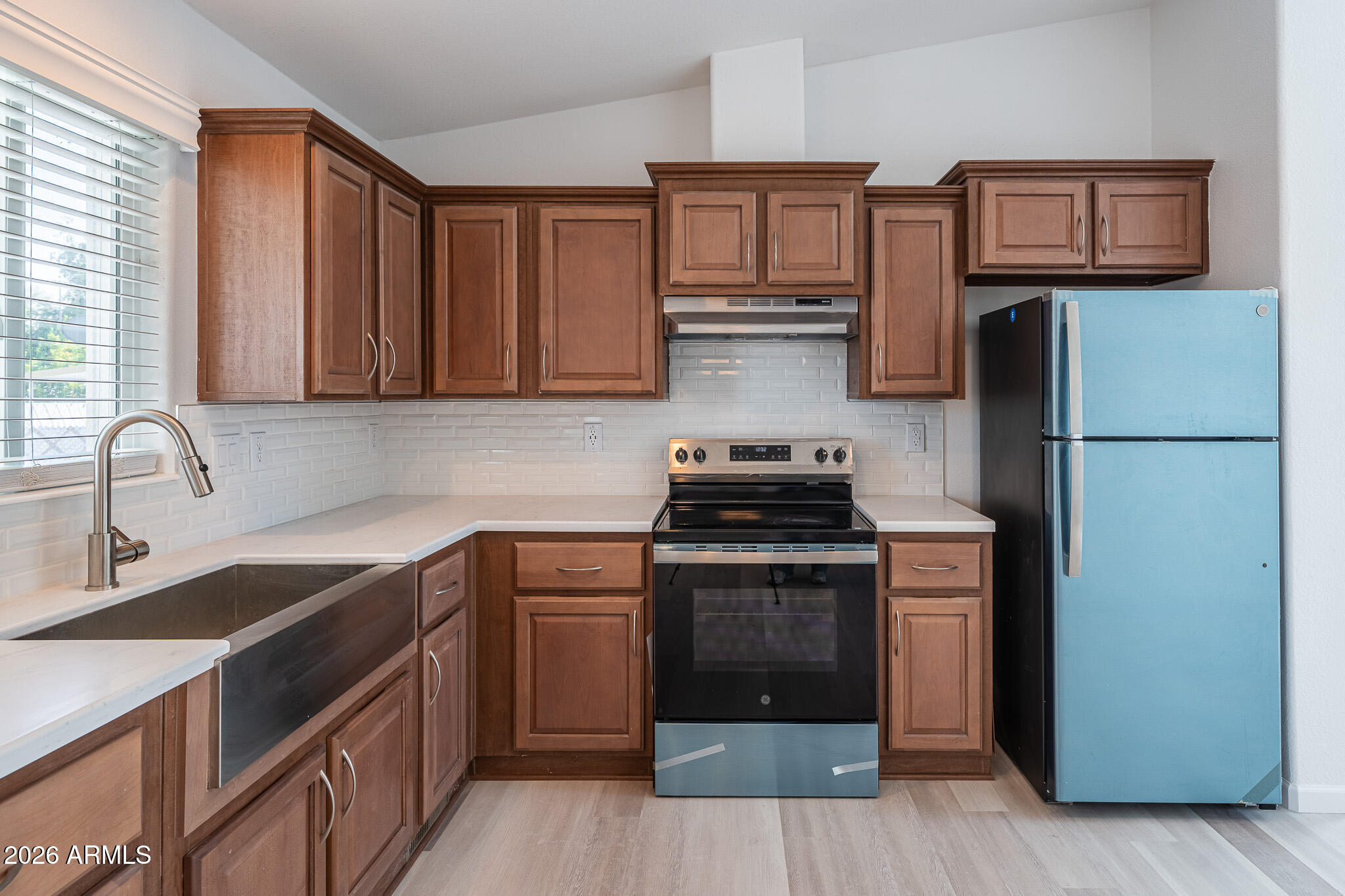 1250 East Bell Road, Unit 11 Phoenix, AZ 85022 - Photo 7 of 24 a kitchen with stainless steel appliances granite countertop a refrigerator stove and sink