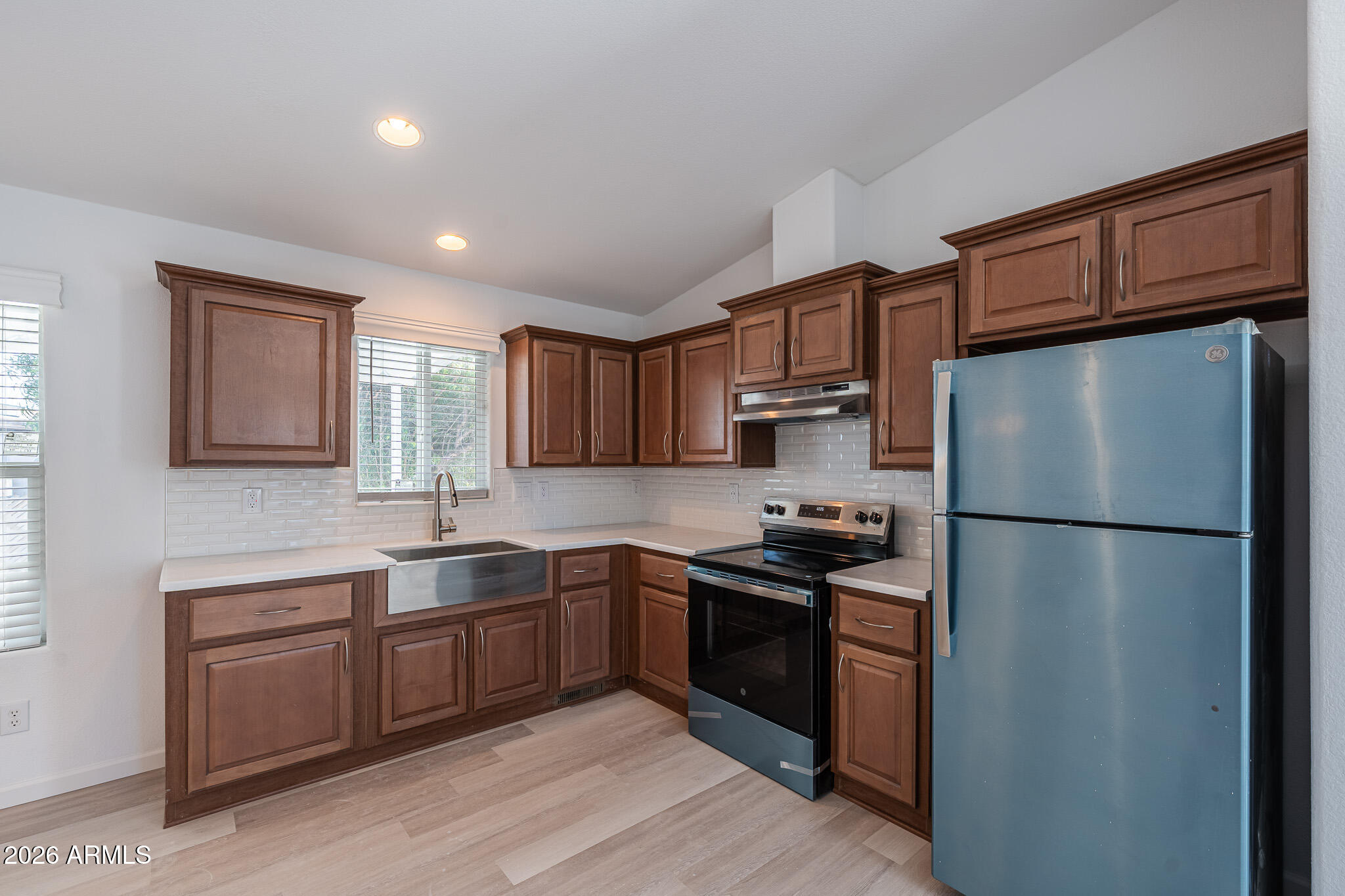 1250 East Bell Road, Unit 11 Phoenix, AZ 85022 - Photo 8 of 24 a kitchen with stainless steel appliances granite countertop a refrigerator stove sink and cabinets