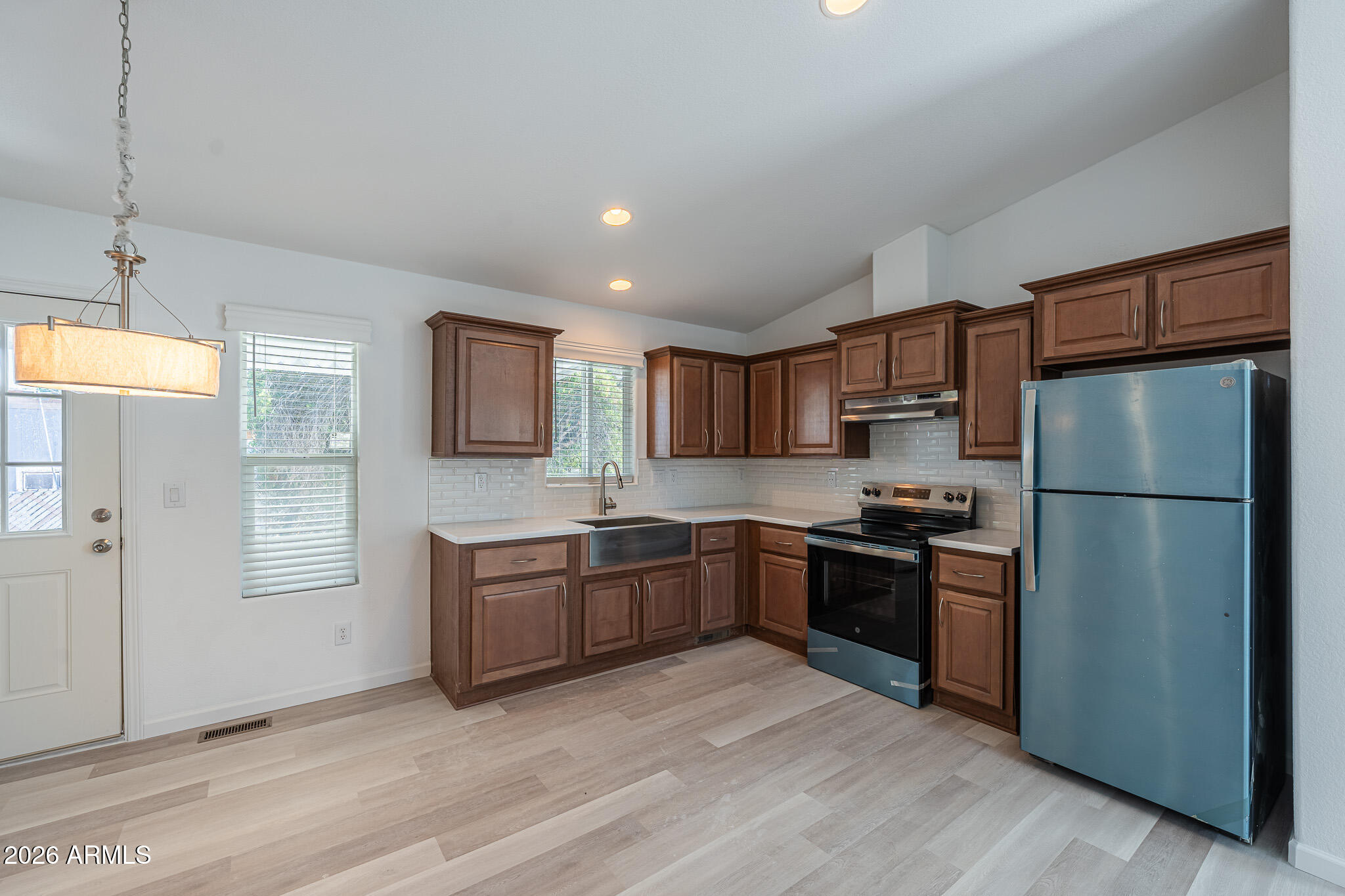 1250 East Bell Road, Unit 11 Phoenix, AZ 85022 - Photo 9 of 24 a kitchen with stainless steel appliances granite countertop a refrigerator a stove top oven a sink and dishwasher