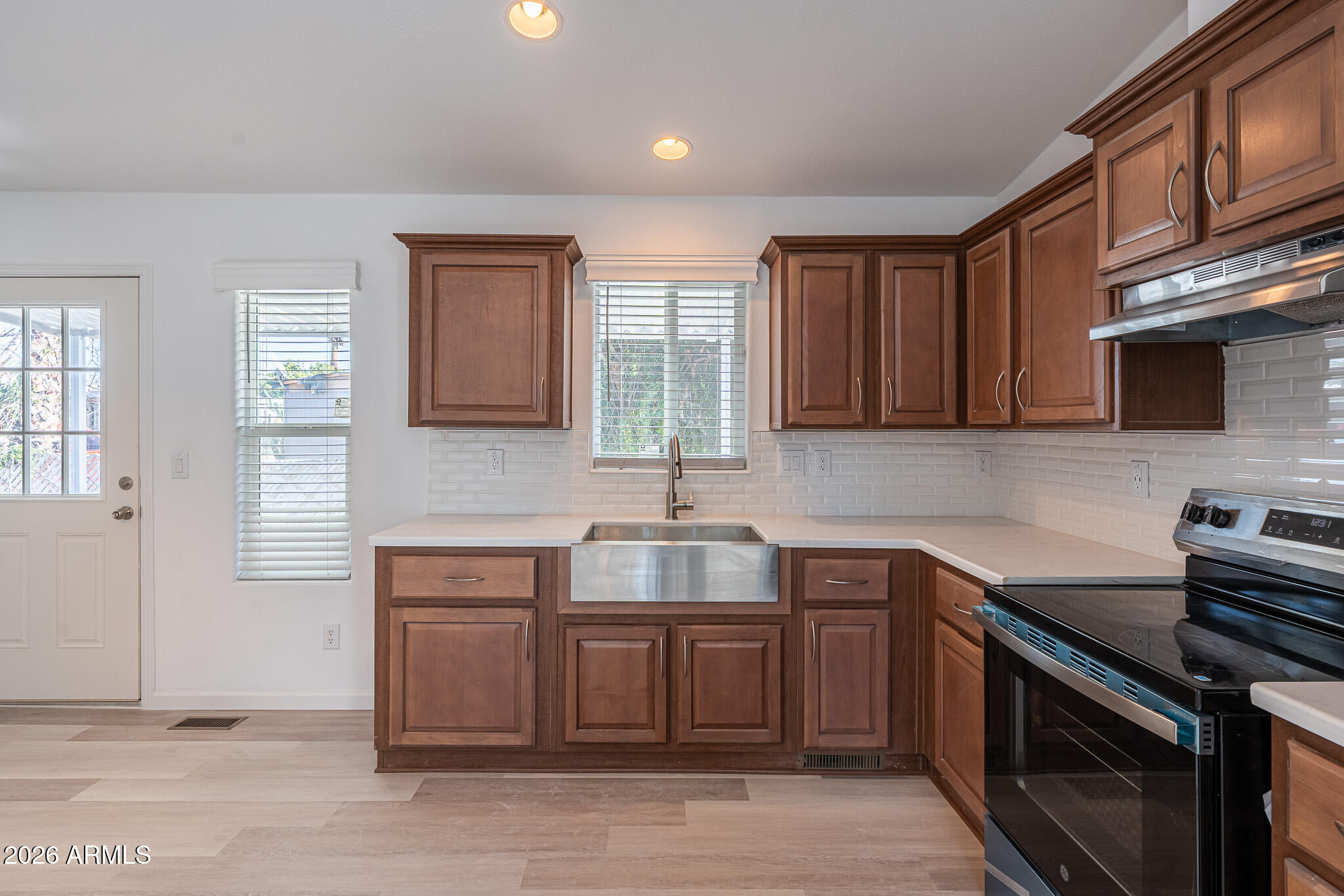 1250 East Bell Road, Unit 11 Phoenix, AZ 85022 - Photo 10 of 24 a kitchen with stainless steel appliances granite countertop a sink stove and cabinets