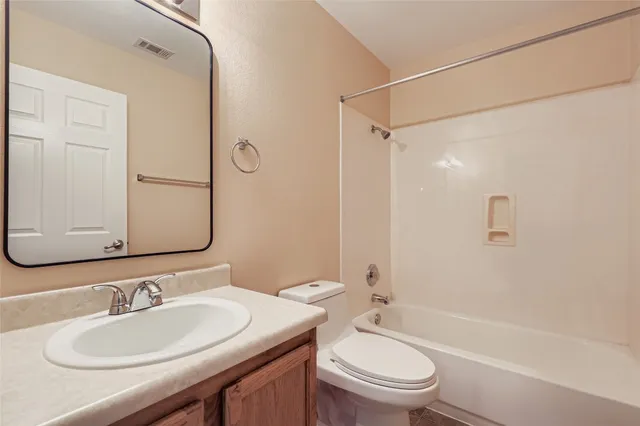 a bathroom with a sink toilet tub and shower