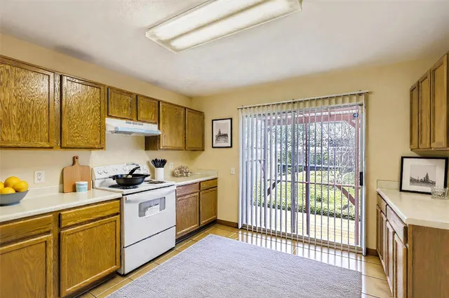 a kitchen with stainless steel appliances granite countertop a stove a sink and a cabinets