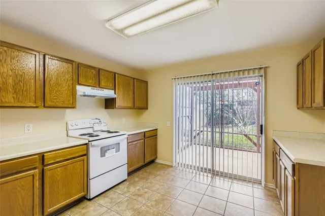 a kitchen with stainless steel appliances granite countertop a sink and cabinets