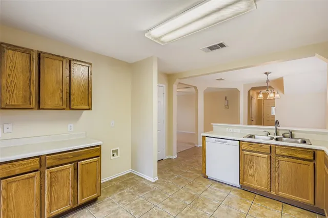 a room with a sink cabinets and utility room