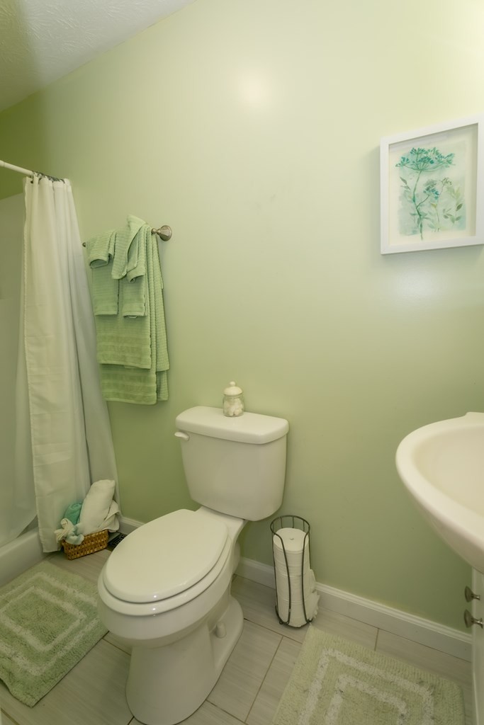 3108 Fortenberry Road Kodak, TN 37764 - Photo 29 of 47 a white toilet sitting next to a bathroom sink and a shower