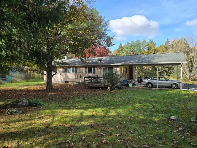 a view of a house with backyard porch and sitting area