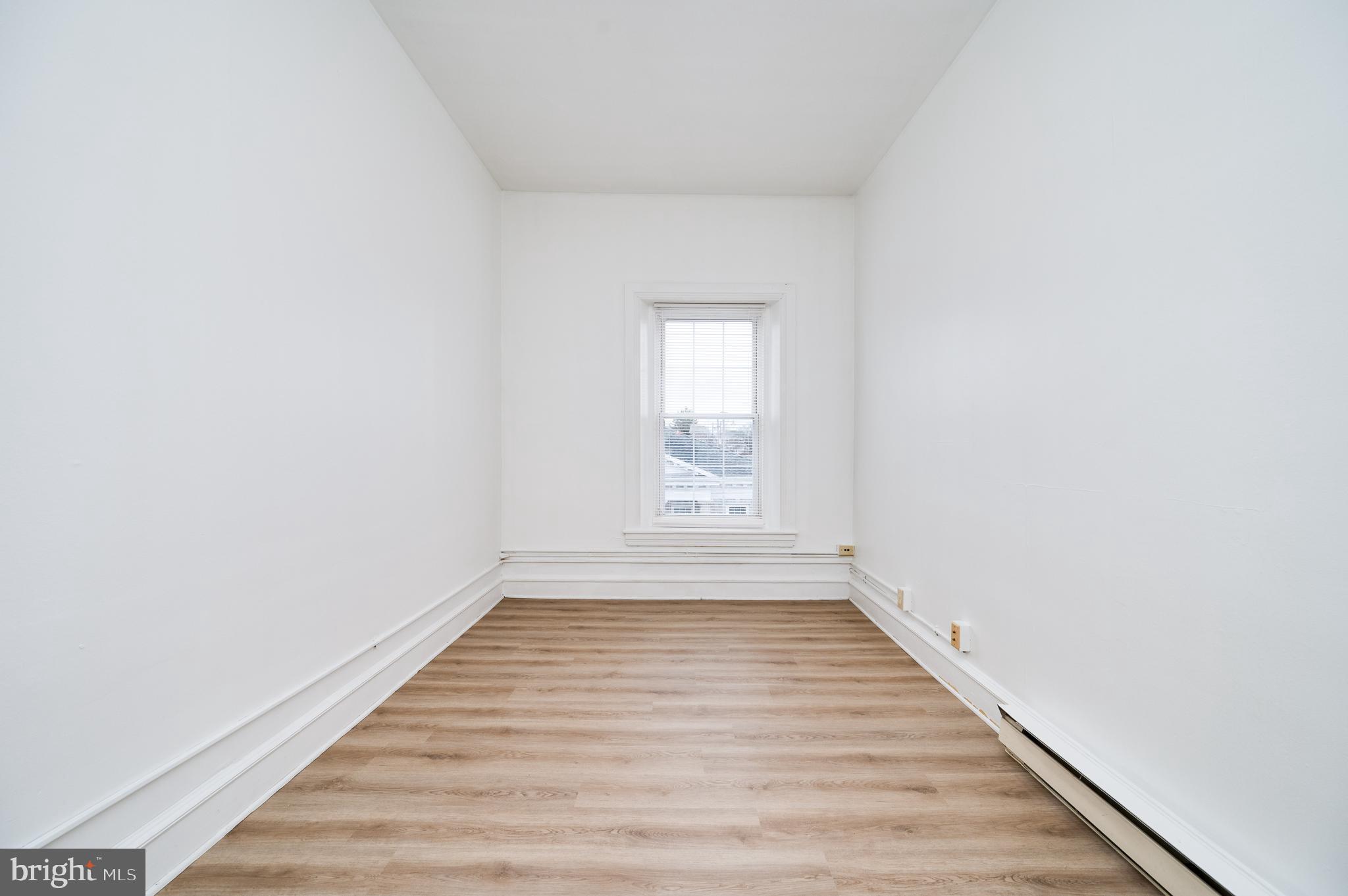 302-4 West Main Street Kutztown, PA 19530 - Photo 16 of 37 a view of an empty room with wooden floor and window