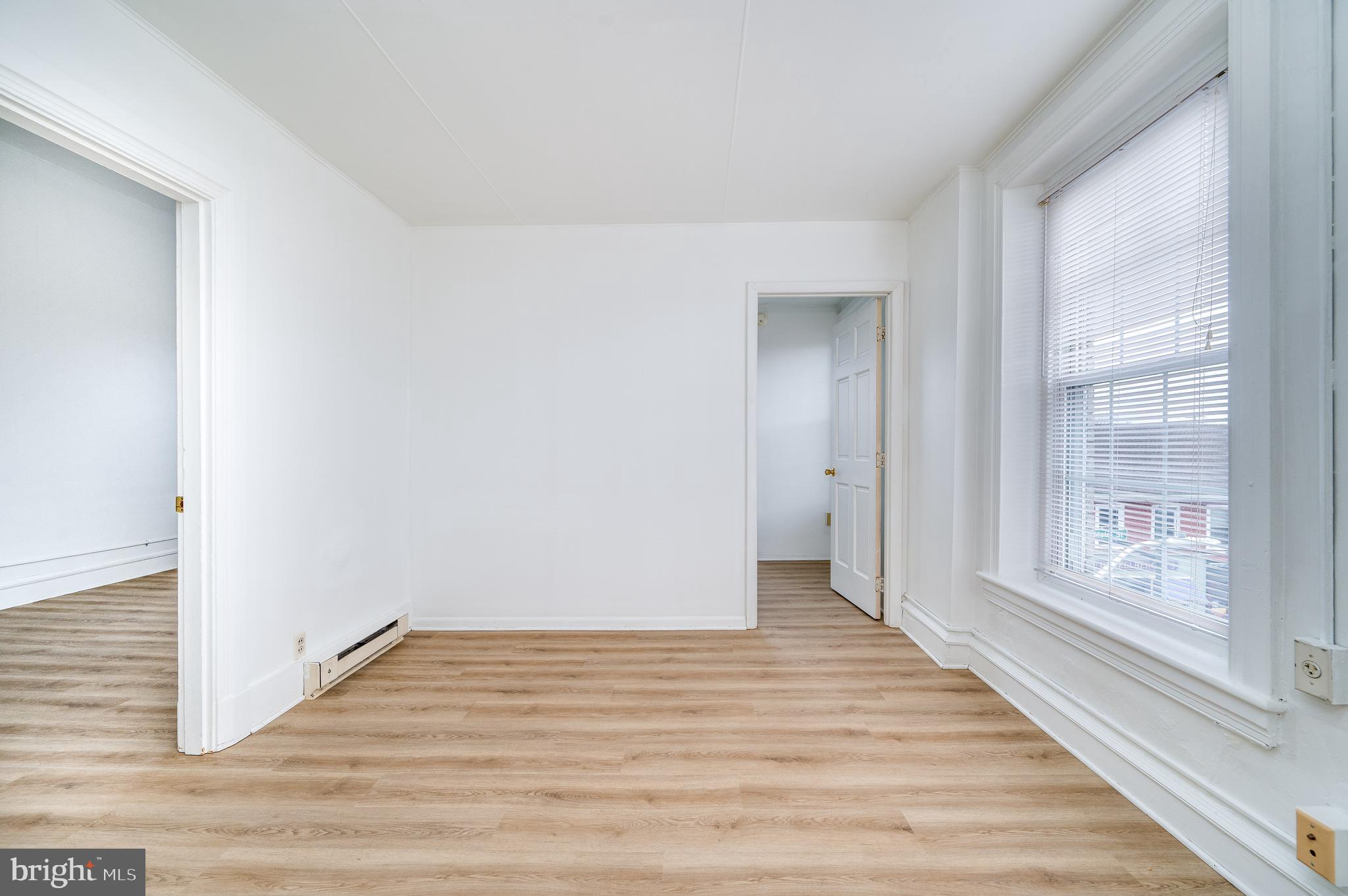 302-4 West Main Street Kutztown, PA 19530 - Photo 19 of 37 a view of an empty room with wooden floor and a window