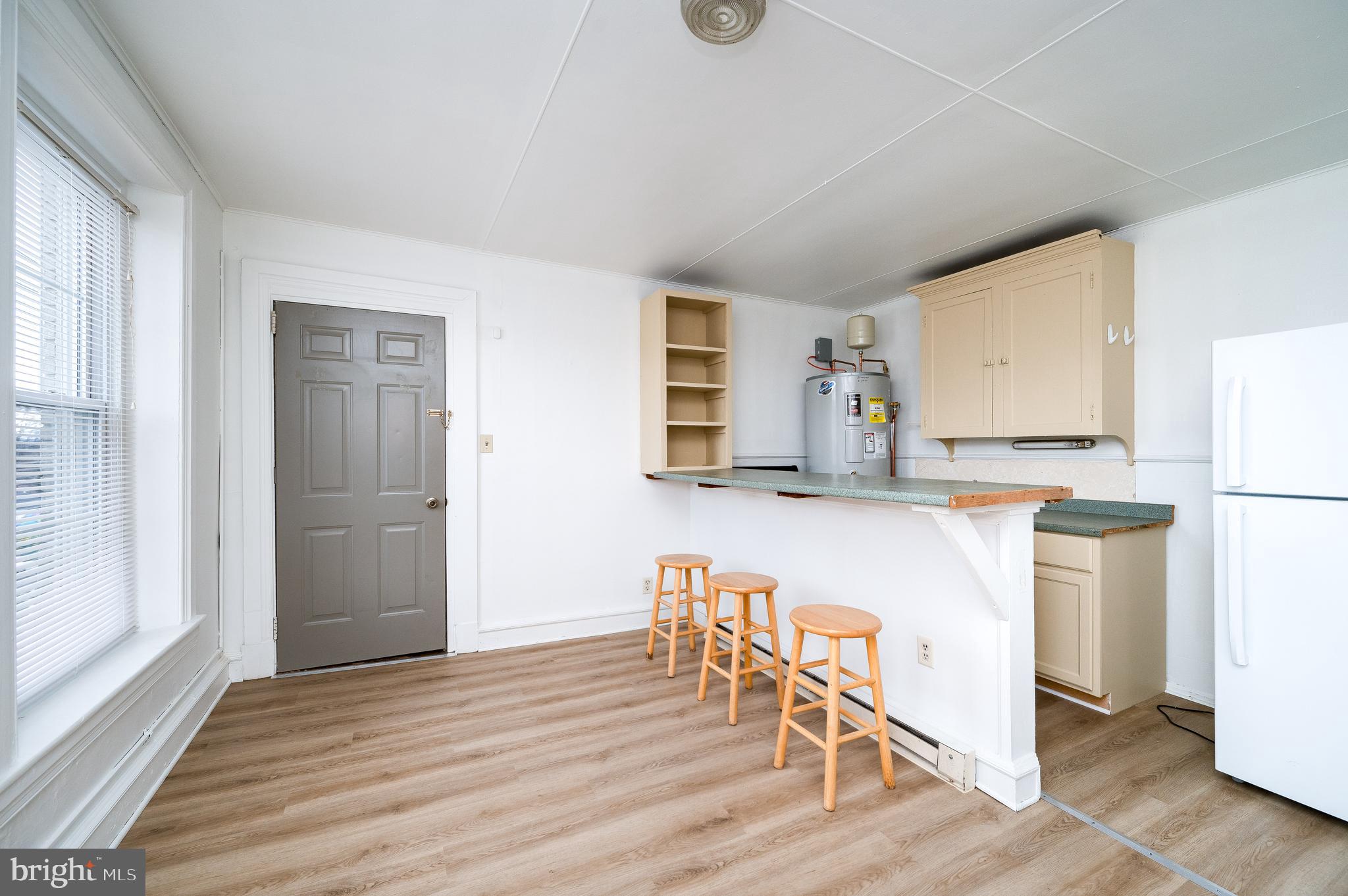 302-4 West Main Street Kutztown, PA 19530 - Photo 10 of 37 a kitchen with granite countertop a refrigerator and wooden floor
