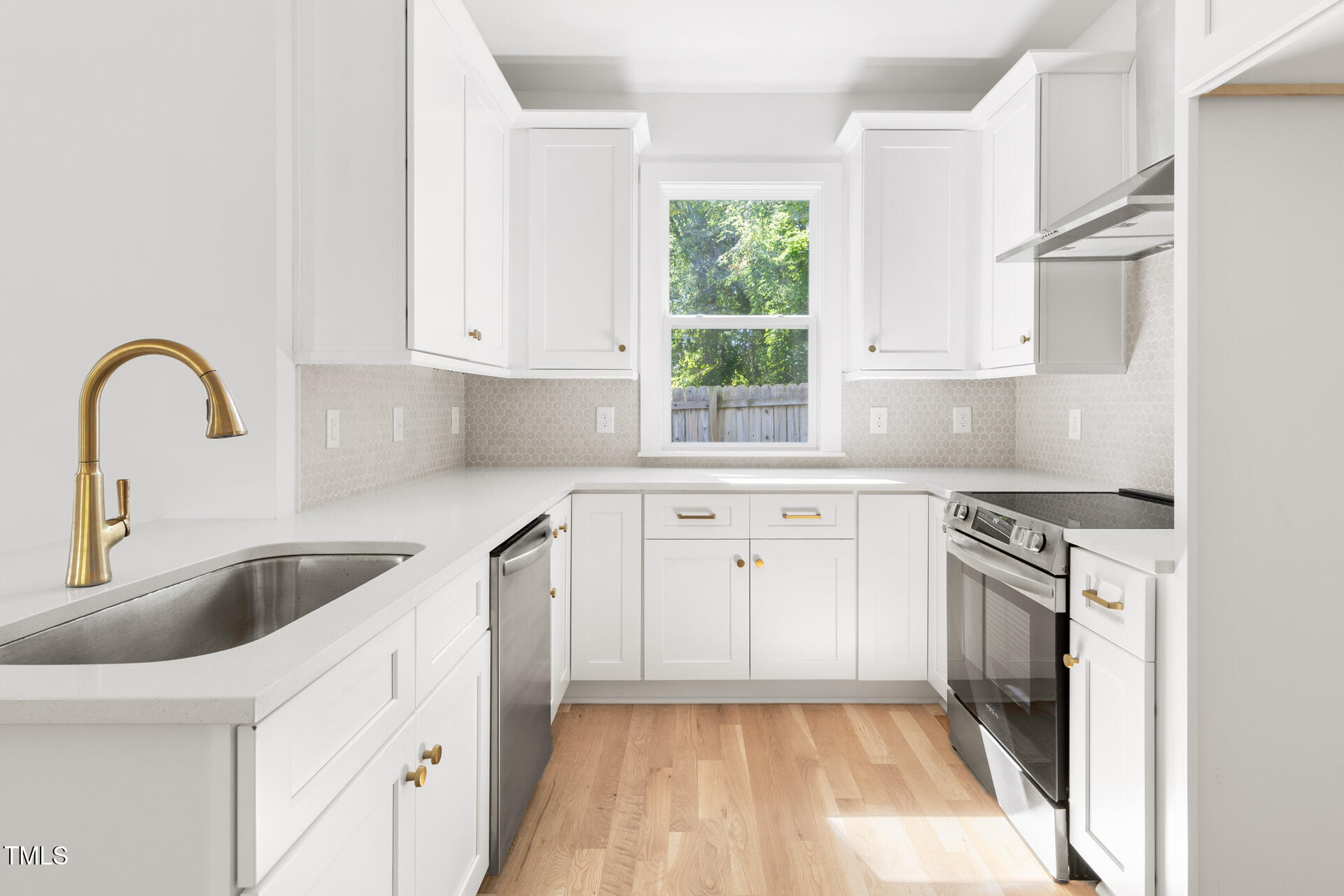 407 B Edward Street Durham, NC 27701 - Photo 12 of 39 a kitchen with granite countertop a sink stainless steel appliances and a window