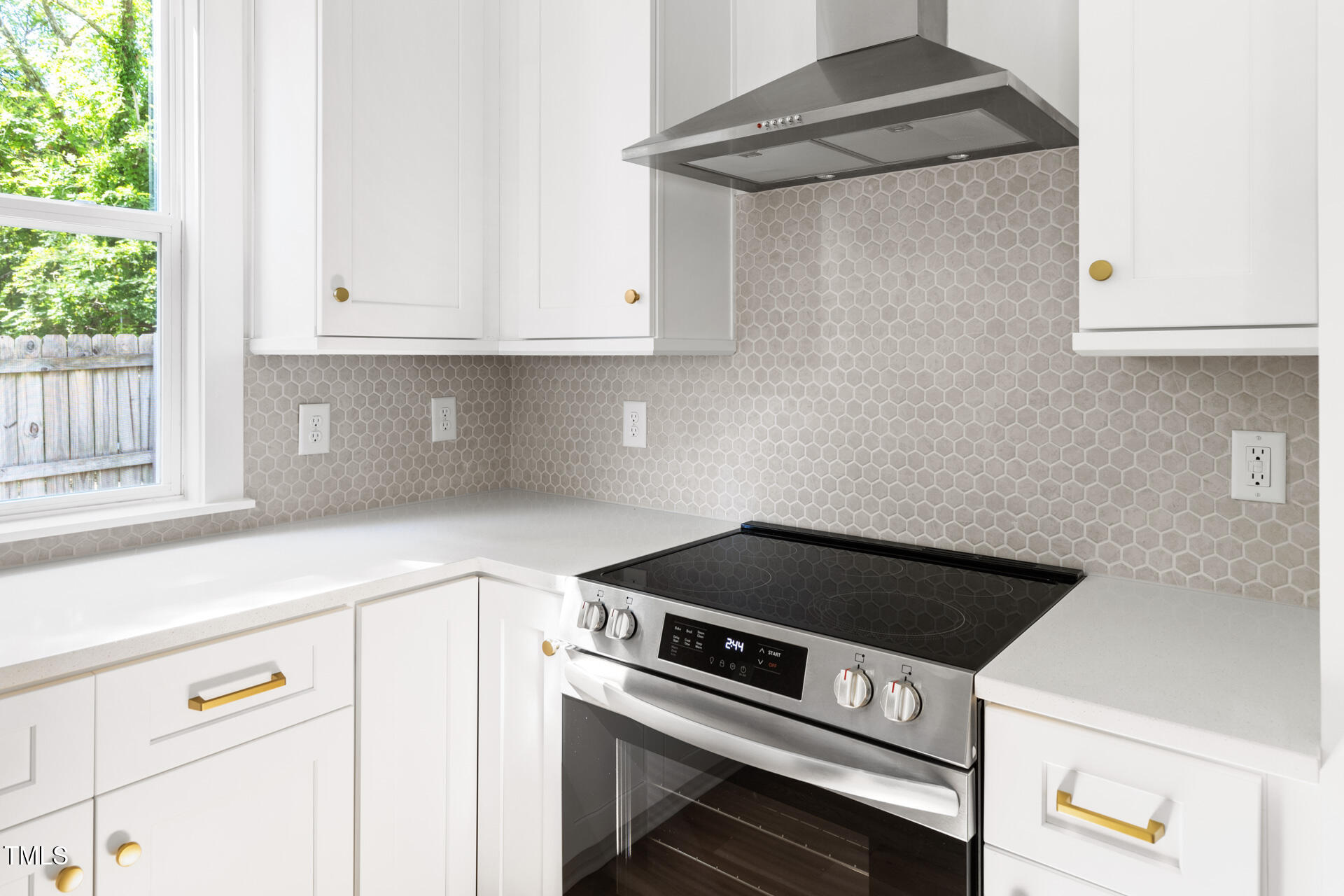 407 B Edward Street Durham, NC 27701 - Photo 13 of 39 a kitchen with a stove and white cabinets