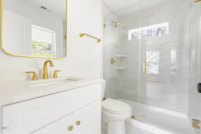 a bathroom with a sink toilet and shower