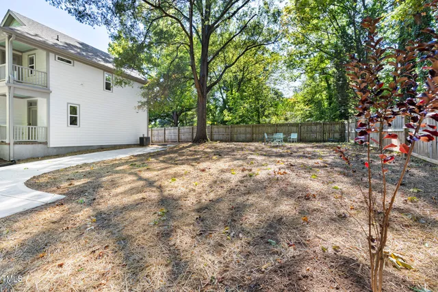 a backyard of a house with large trees