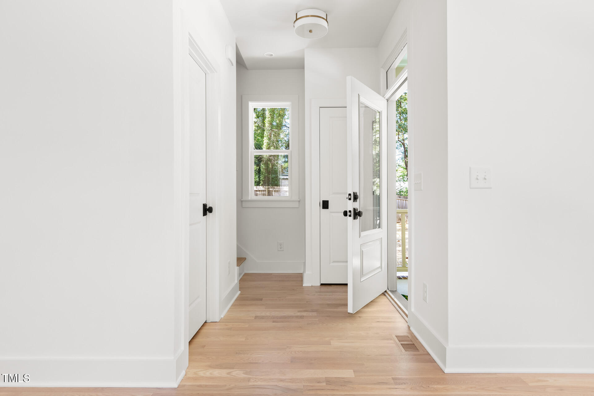 407 B Edward Street Durham, NC 27701 - Photo 5 of 39 a view of a hallway with wooden floor and a bathroom