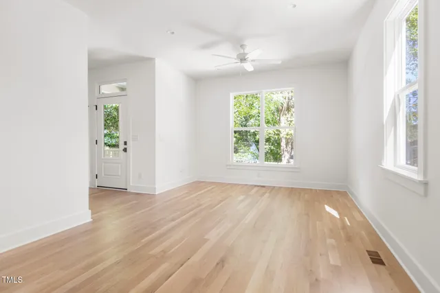 wooden floor in an empty room with a window