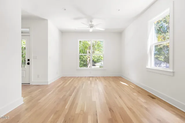 wooden floor in an empty room with a window