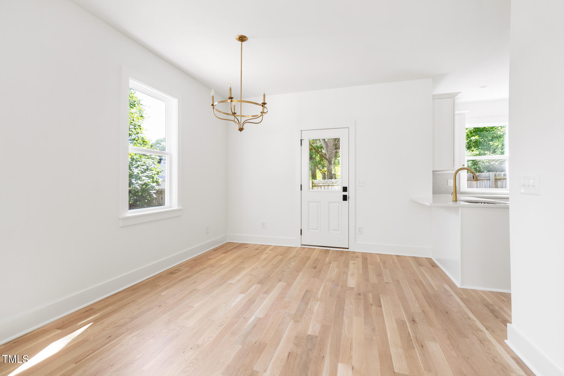 407 B Edward Street Durham, NC 27701 - Photo 9 of 39 a view of empty room with window and wooden floor