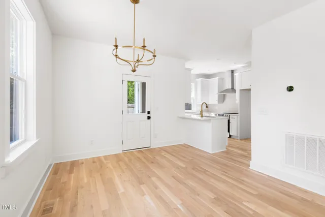 a view of a kitchen and a sink dishwasher a refrigerator with wooden floor