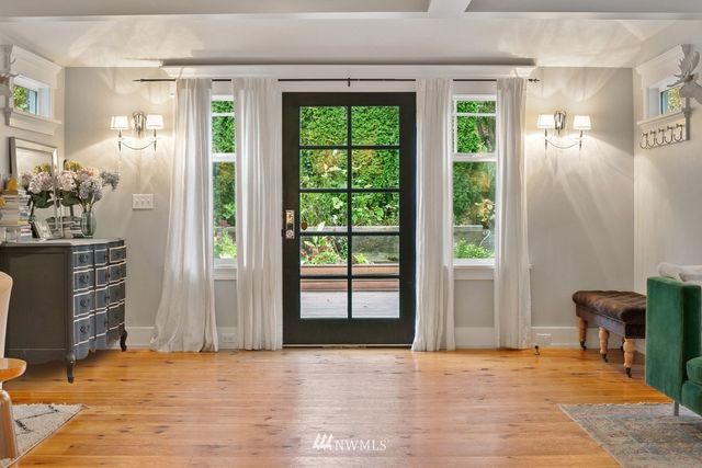 a view of an empty room with a window and bathroom
