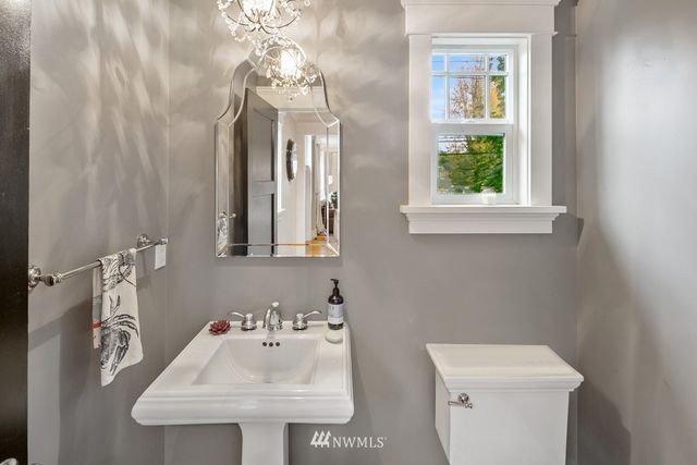 a bathroom with a sink a toilet and a mirror