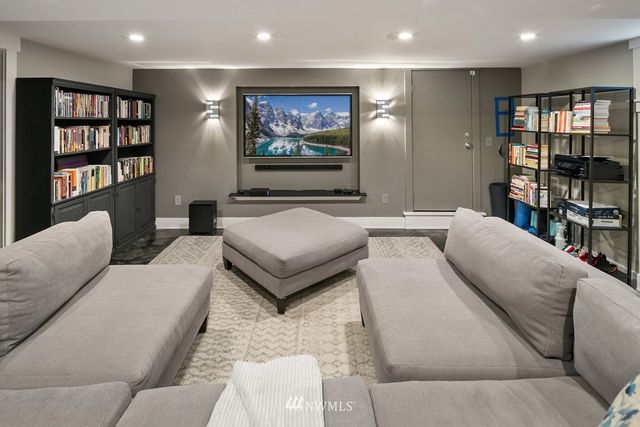 a living room with furniture and a book shelf