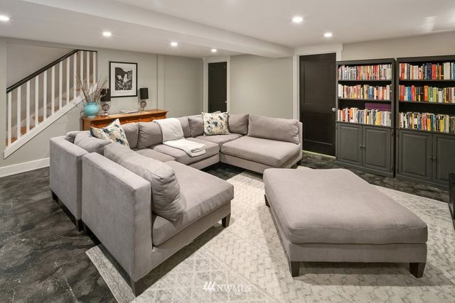 a living room with furniture and a book shelf