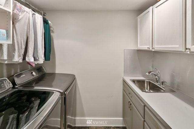 a kitchen with a sink and a stove top oven