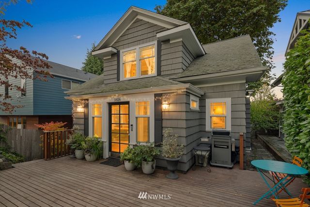 a view of house with patio outdoor seating and wooden floor