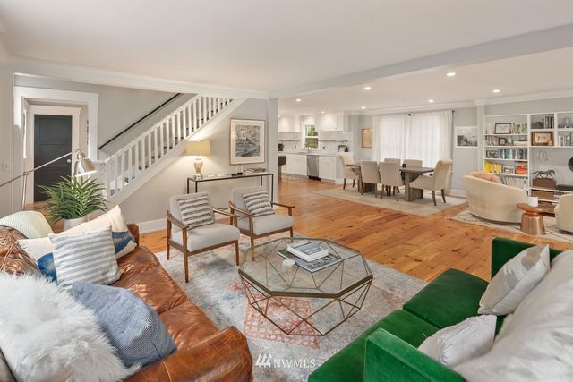 a living room with furniture kitchen view and a table