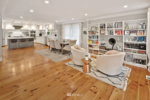 a living room with furniture and a book shelf
