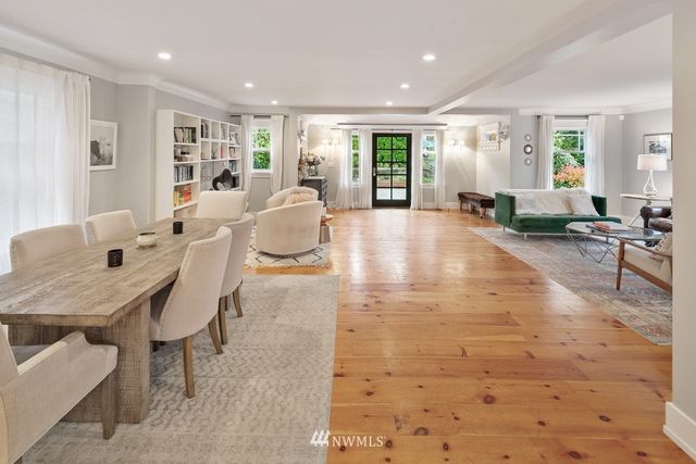 a living room with furniture a window and wooden floor