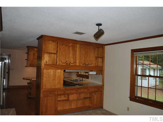 610 Buffaloe Road Garner, NC 27529 - Photo 15 of 25 a kitchen with a refrigerator and cabinets