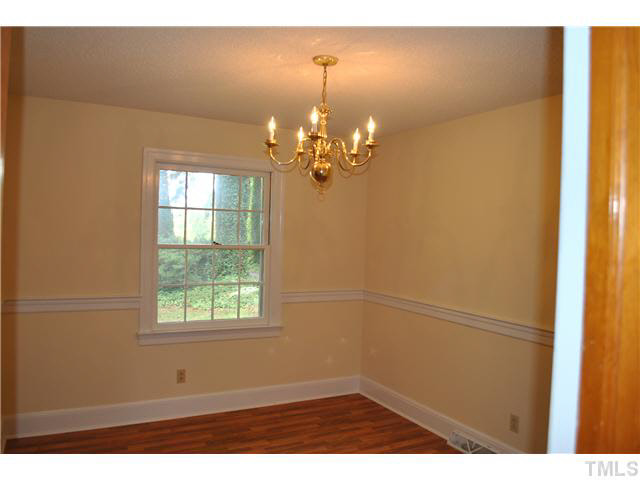 610 Buffaloe Road Garner, NC 27529 - Photo 20 of 25 a bathroom with a window and a chandelier