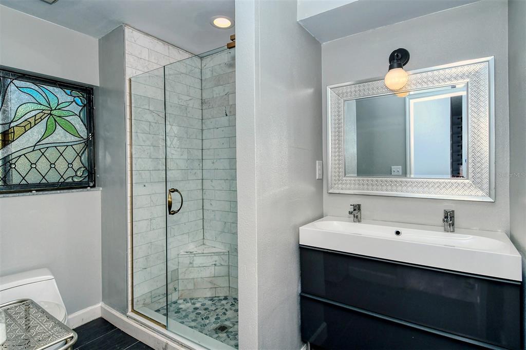 450 Beach Road, Unit 5 Sarasota, FL 34242 - Photo 24 of 59 Ensuite master bathroom with dual sinks and enclosed walk in shower.