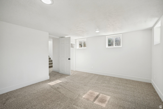 662 29th Street Ogden, UT 84403 - Photo 13 of 23 Spacious room featuring neutral carpeting, white walls, recessed lighting, and multiple windows